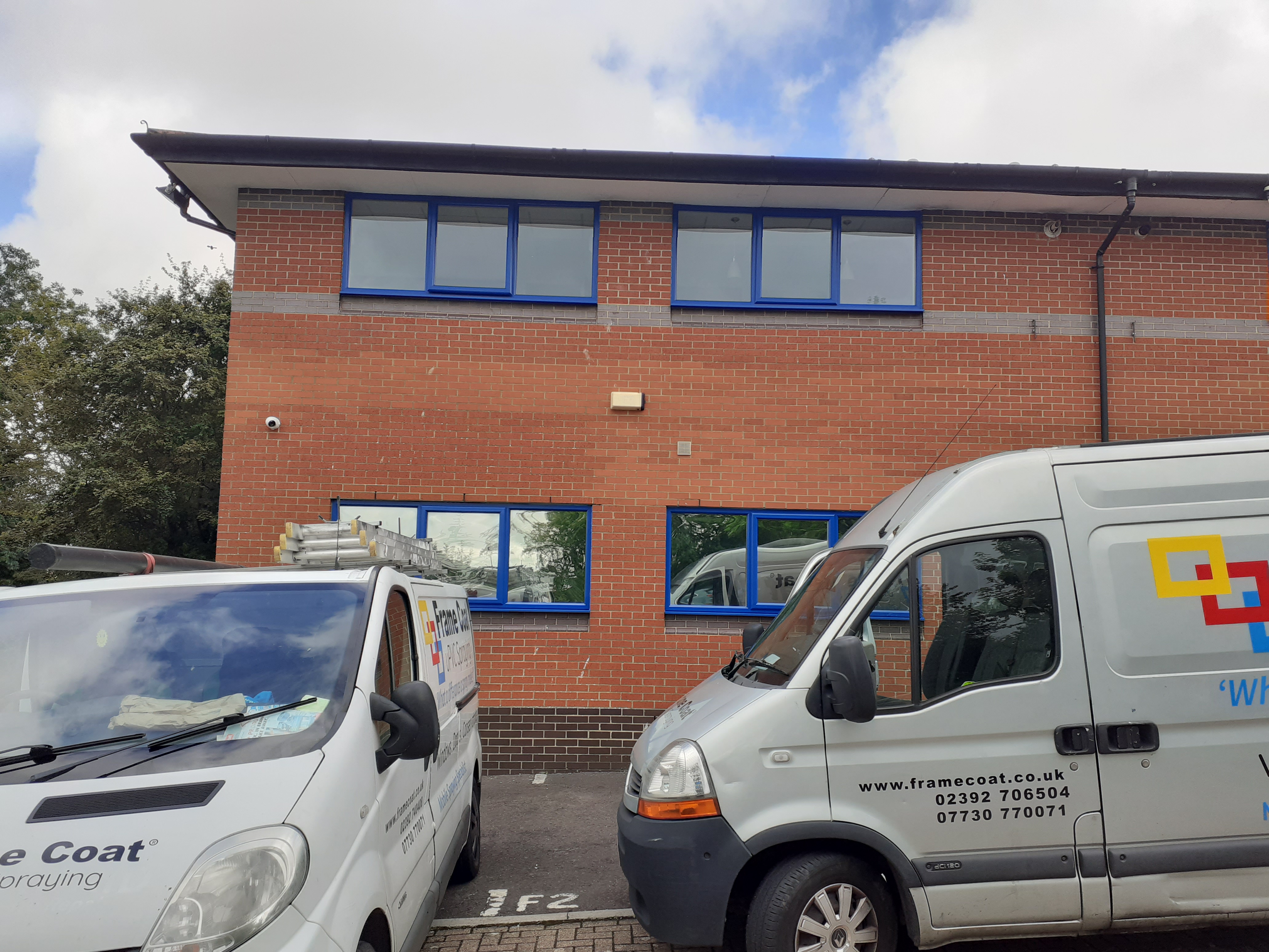 Two Frame Coat vans on site during a commercial spraying project