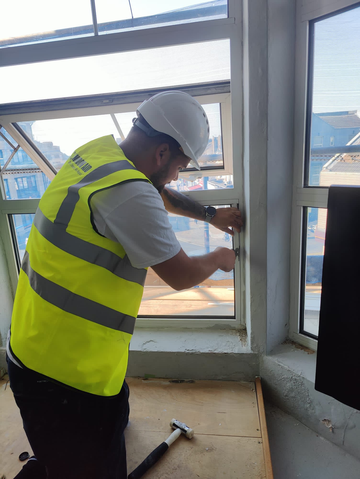 Technician performing on-site window unit replacement and refurbishment