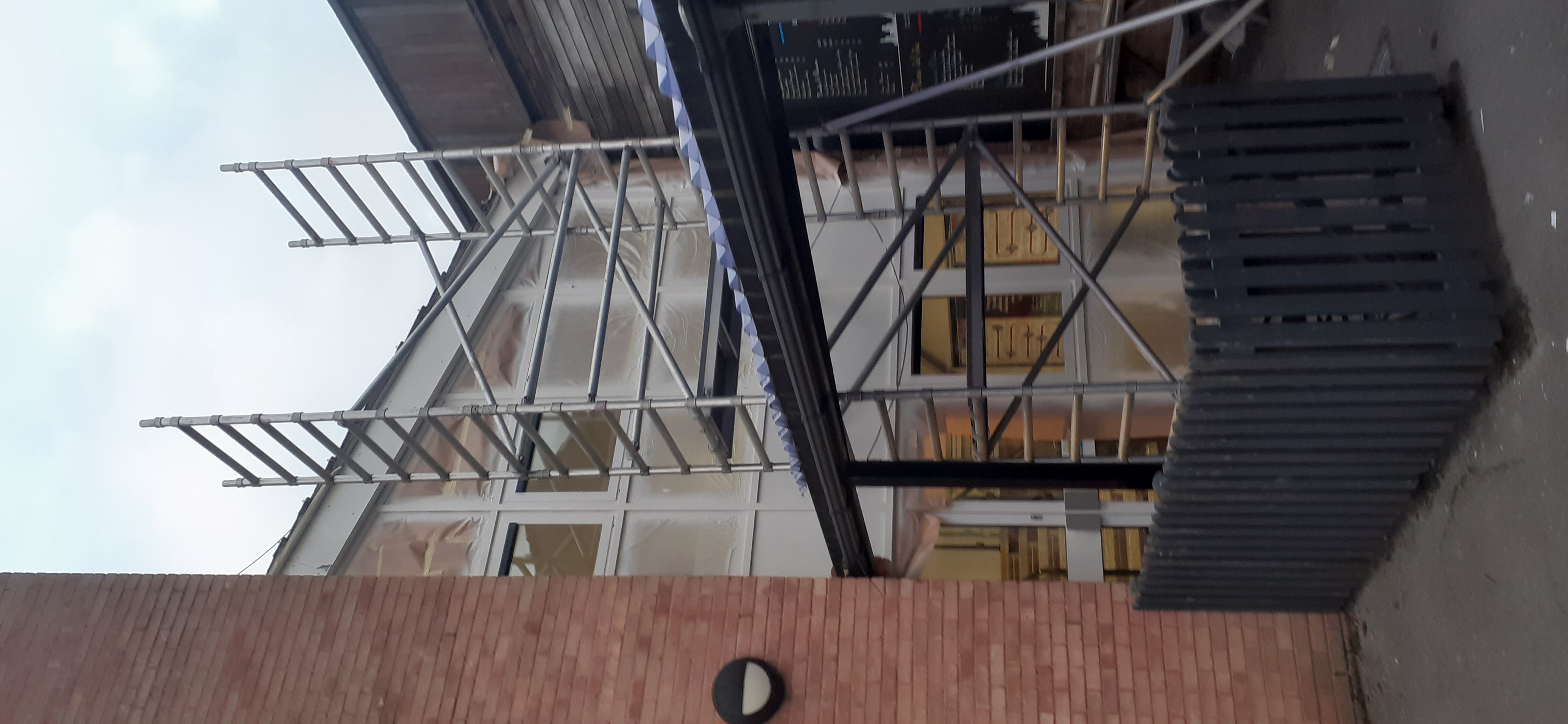 Stairwell frames being recoloured on site — coating in progress